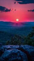 Sun Setting Over Distant Mountains photo