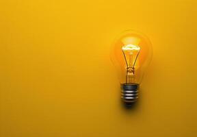 A Single Lit Light Bulb On A Yellow Background photo