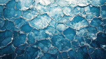 Cracked blue ice with clear water beneath at a frozen lake during winter photo