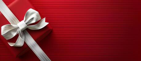Red Gift Box With Silver Bow on Striped Red Background photo