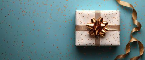 White Gift Box With Gold Ribbon on Blue Background photo