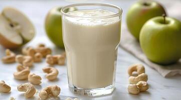 Creamy Apple Cashew Smoothie With Green Apples on a Wooden Table photo