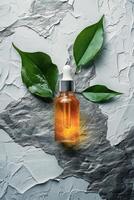 Botanical drops on textured surface with green leaves and liquid container photo
