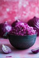 Chopped purple cabbage salad with fresh greens on a wooden cutting board photo