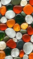 Colorful collection of polished stones showcasing various shapes and sizes on a flat surface photo