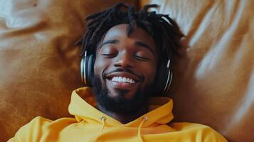 Young man relaxing on a couch while listening to music in a cozy indoor space photo