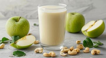 Creamy Apple Cashew Smoothie With Green Apples on a Wooden Table photo