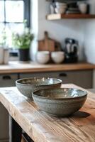 Simple ceramic bowls on a wooden table in a bright and airy setting with natural light photo
