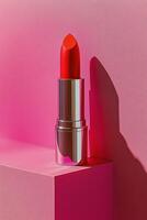 A vibrant red lipstick stands elegantly against a vivid pink backdrop in a minimalist setting photo