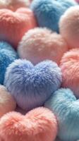 Colorful fluffy heart shaped decorations on a soft surface arranged with pastel colors photo