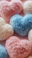 Colorful fluffy heart shaped decorations on a soft surface arranged with pastel colors photo