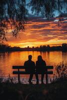 Couple enjoying a sunset while sitting on a bench in a peaceful park during autumn evening photo