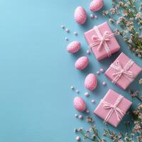 Colorful Easter gifts and decorated eggs arranged on a blue background with spring elements photo