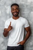 Young man showing number one gesture with a confident smile against a textured gray background photo