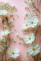 Delicate white flowers and tiny blossoms against a soft pink background in a serene arrangement photo