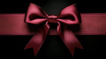 Elegant red satin bow on a dark background perfect for gift wrapping and decoration photo