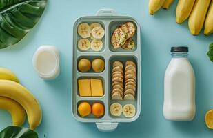 Fresh and colorful lunch boxes with fruits and sandwiches on a light blue background photo
