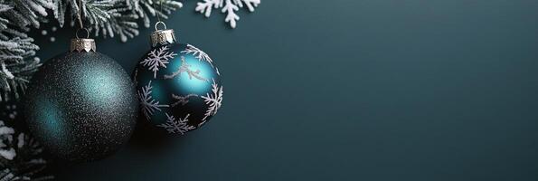 Decorative Christmas ornaments hanging on a snowy pine branch against a dark background photo