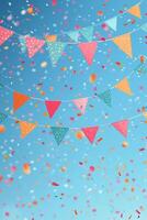 Colorful festive bunting and vibrant confetti against a bright blue sky on a joyful occasion photo