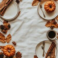 Autumn table setting with pumpkins, plates, and pine cones for a cozy gathering in fall photo