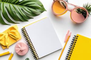A stack of colorful notebooks and a blank notepad arranged neatly on a wooden table photo