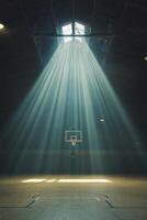 Light streaming into an empty basketball court creating a dramatic atmosphere photo