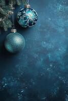 Festive blue and silver ornaments hang amid swirling snowflakes in a winter themed display photo
