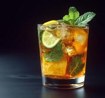 Refreshing drink with mint and orange served in a glass filled with ice photo