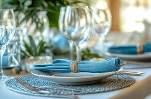 Elegant table setting with blue accents at a dining event during daylight photo