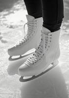Bright white ice skates gliding on smooth ice in an indoor rink during a winter afternoon photo