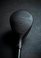 The elegance of a sleek black golf club against a dark background in studio lighting photo