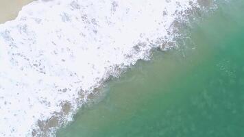 waves of a calm and turquoise colored sea on the shore of a beach, background for beach concept video