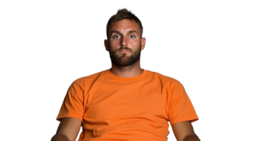 Man in orange t shirt sitting with a neutral expression on a transparent background png