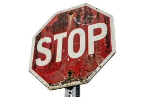 Weathered stop sign, close-up view. Sign shows wear and fading, adding character and history, set against a plain background. png