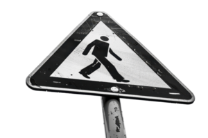 Close-up of a worn pedestrian crossing sign with a triangular shape, featuring a walking person icon, isolated on a transparent background. png