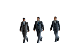 Miniature figurines of three businessmen in suits walking against a transparent background. representing teamwork and business collaboration. png