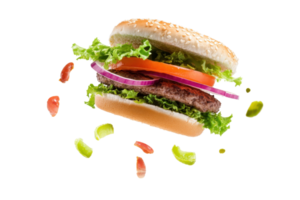 A delicious cheeseburger with fresh lettuce, tomato, red onion, and crispy bun, isolated on transparent background. with falling vegetable pieces. png