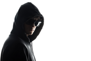 Mysterious man in hoodie and sunglasses on dark background, exuding an enigmatic and secretive aura. png