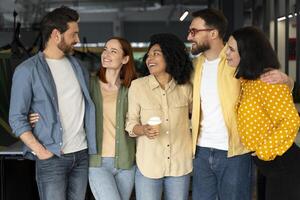 Diverse business team enjoying a coffee break together in the office photo