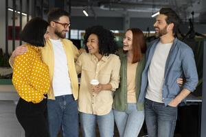 Group of diverse business people smiling and having fun in modern office photo