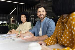 Marketing team having brainstorming session discussing new project in modern office photo