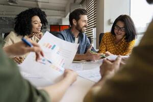 Group of business people having meeting discussing new project startup charts plans brainstorming teamwork concept photo