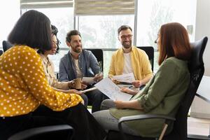 Group of businesspeople having meeting discussing new project in modern office photo