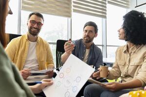 Business team having meeting discussing new project using charts and graphs photo