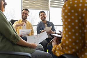 Marketing team having a productive meeting discussing charts and reports photo