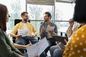Creative business team brainstorming discussing business ideas using charts and graphs photo