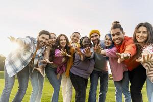 Group of diverse people reaching out with open arms photo