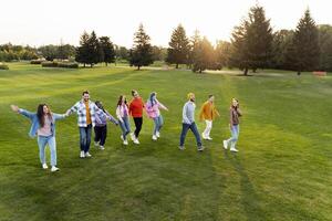 Group of friends walking together in park photo