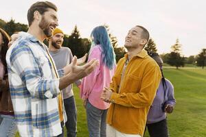 Group of diverse friends laughing and having fun together outdoors photo