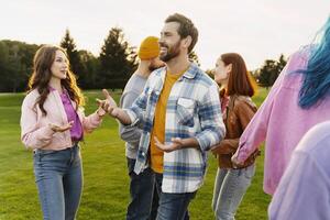 Group of friends having fun and talking together in park photo